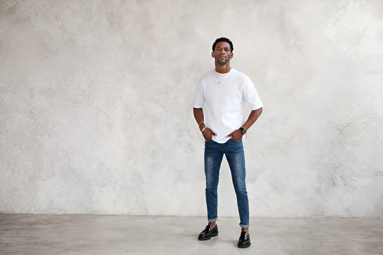 man wearing a white shirt, jeans, and black loafers